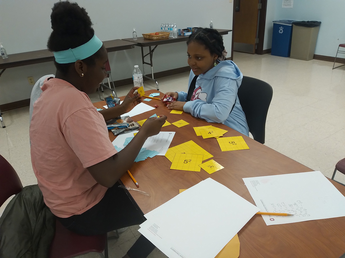 Two girls playing the sum of squares game.