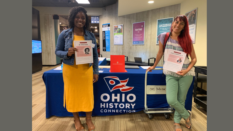 Ranthony and Monica posing in front of Ohio History Connection table after Professional Development Session